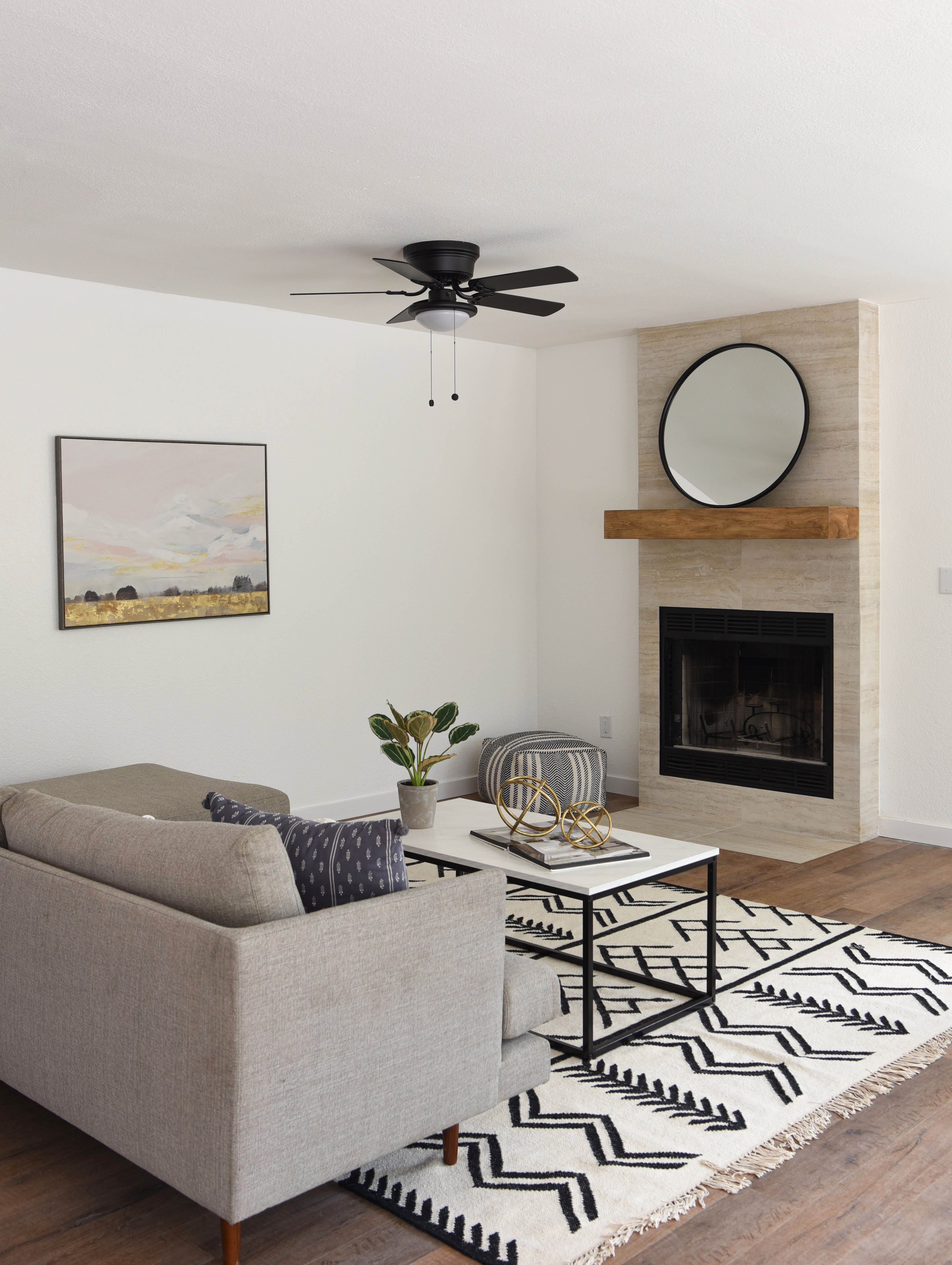 Living room with a corner fireplace as the focal point, sofa and coffee table arranged to face it